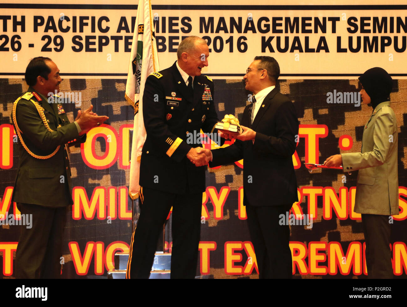 U.S. Army Gen. Robert B. Brown, Commander, U.S. Army Pacific and Lt. Gen. Dato’ Sri Zulkiple, Field Commander West, Malaysian Army present a memento to the Honorable Dato’ Seri Hishmuddin, Minister of Defence Malaysia during the opening ceremony for PAMS 2016, in Kuala Lumpur, Malaysia, September 26. PAMS is an annual multinational military seminar providing a forum for senior level ground force officers from regional ground forces and security forces to meet, exchange views and discuss professional military subjects. This year’s theme is "Unity of Effort: Building Civil-Military Partnerships Stock Photo