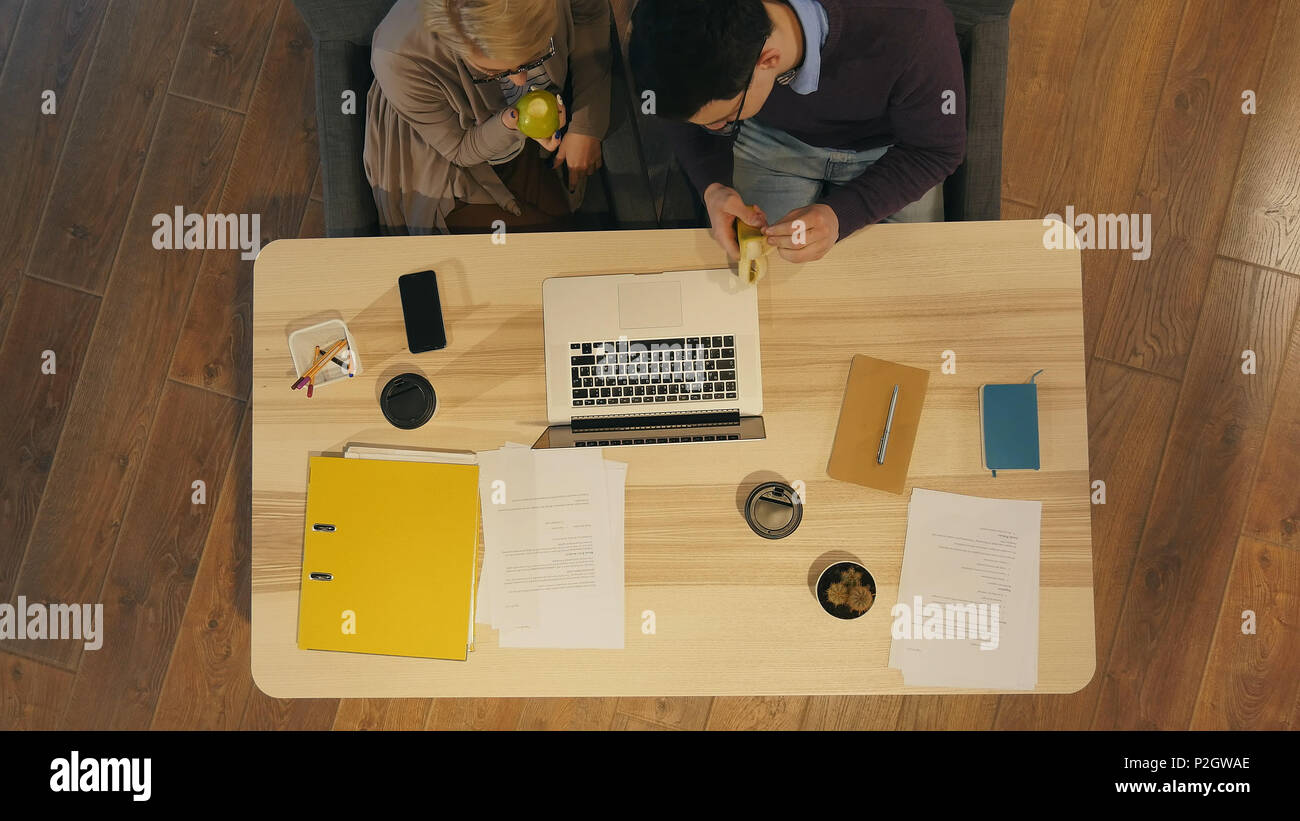 Workers enjoying lunch break in the office Stock Photo