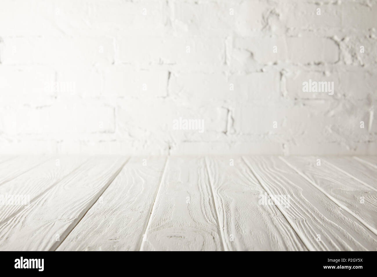 white wooden tabletop and white wall with bricks Stock Photo Alamy