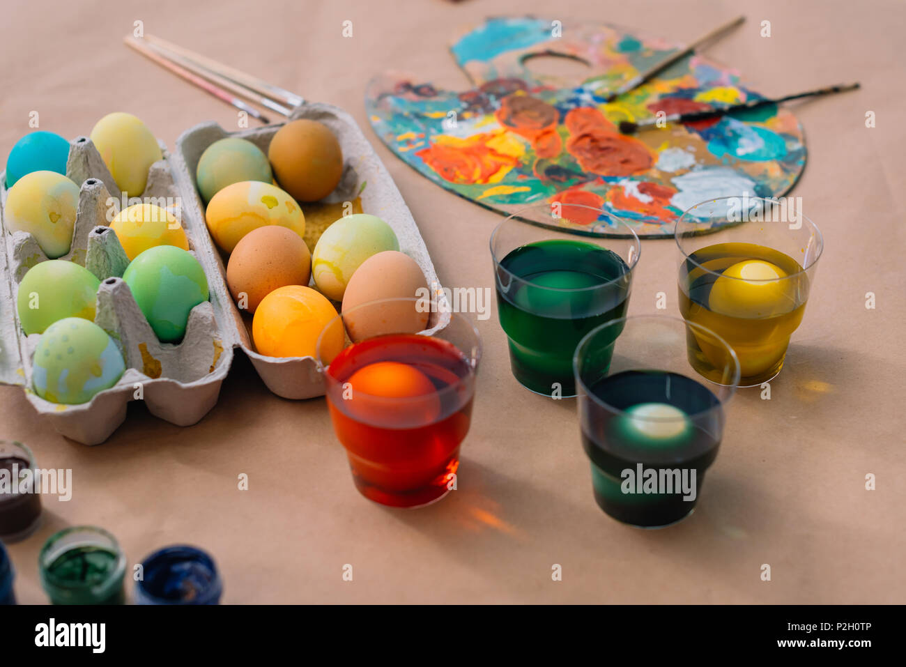 freshly painted easter eggs with paint on table Stock Photo