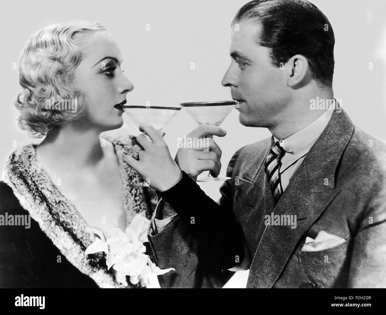 Description: RELEASED: Nov 25, 1932 - Original Film Title: No More Orchids. PICTURED: CAROLE LOMBARD, LYLE TALBOT..  Original Film Title: NO MORE ORCHIDS.  English Title: NO MORE ORCHIDS.  Film Director: WALTER LANG.  Year: 1932.  Stars: LYLE TALBOT; CAROLE LOMBARD. Credit: COLUMBIA PICTURES / Album Stock Photo
