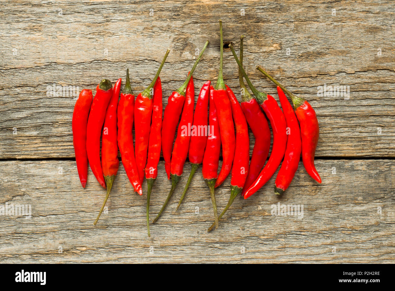 Chili hot red on a wooden rustic background Stock Photo - Alamy