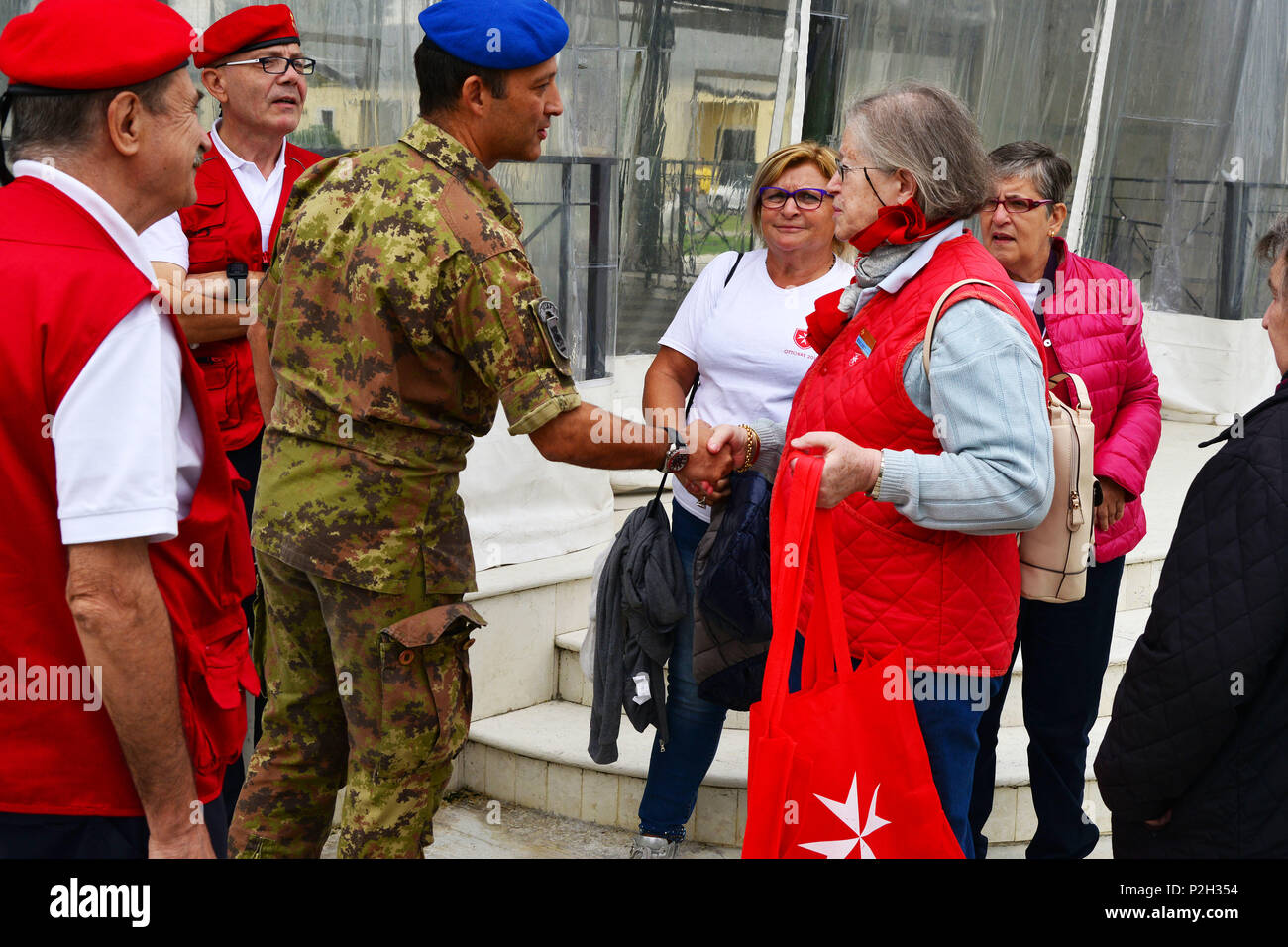 Colonel Umberto D’Andria, Italian Base Commander Caserma Ederle of Vicenza (left), greets Ms. Maria Giulia Medolago Albani, Sovereign Military Order of Malta (right), during the visit at caserma Ederle, 22 Sept. 2016, Vicenza, Italy. The Sovereign Military Order of Malta (SMOM) or Order of Malta, is a Roman Catholic  Religious Order traditionally of military, chivalrous and noble nature for defense of Catholic faith and assistance to the poor. (U.S. Army photo by Visual Information Specialist Paolo Bovo/Released) Stock Photo