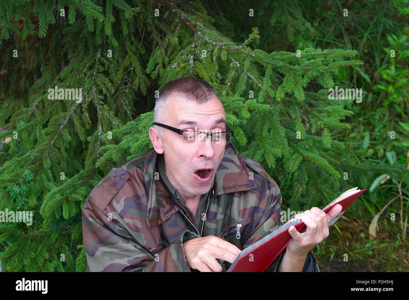 Man reading book under tree hi-res stock photography and images - Alamy