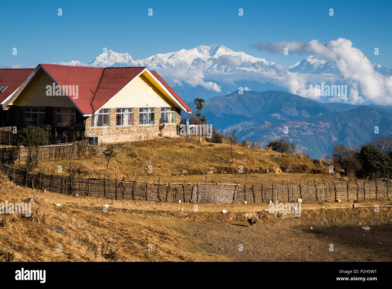 landscape of Tonglu trekkers hut and Kangchenjunga mount during blue sky day time. This place is middle way to Sandakphu, north of India Stock Photo