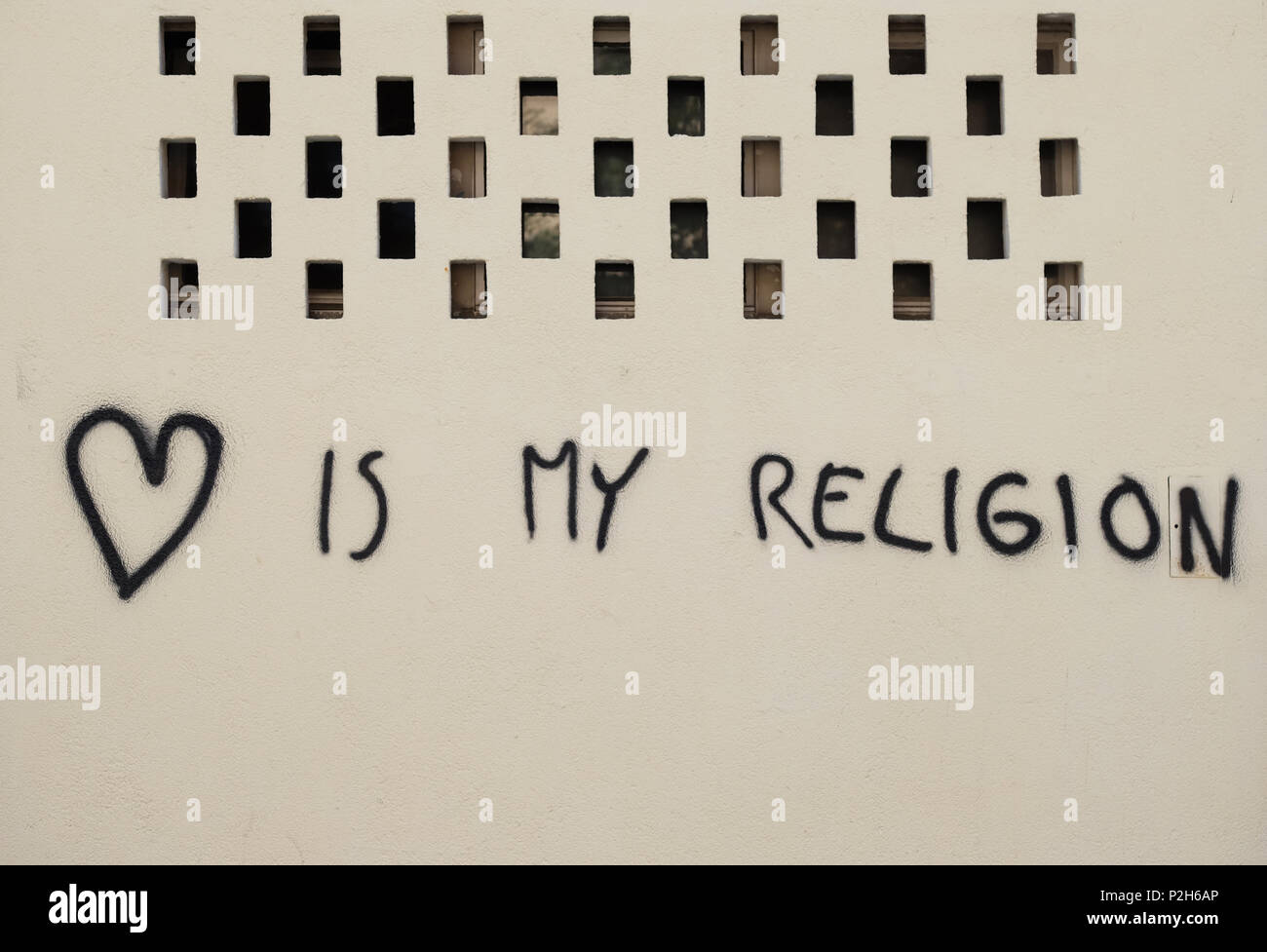 Love is my religion, graffiti on the facade of the house in Cakovec, Croatia Stock Photo