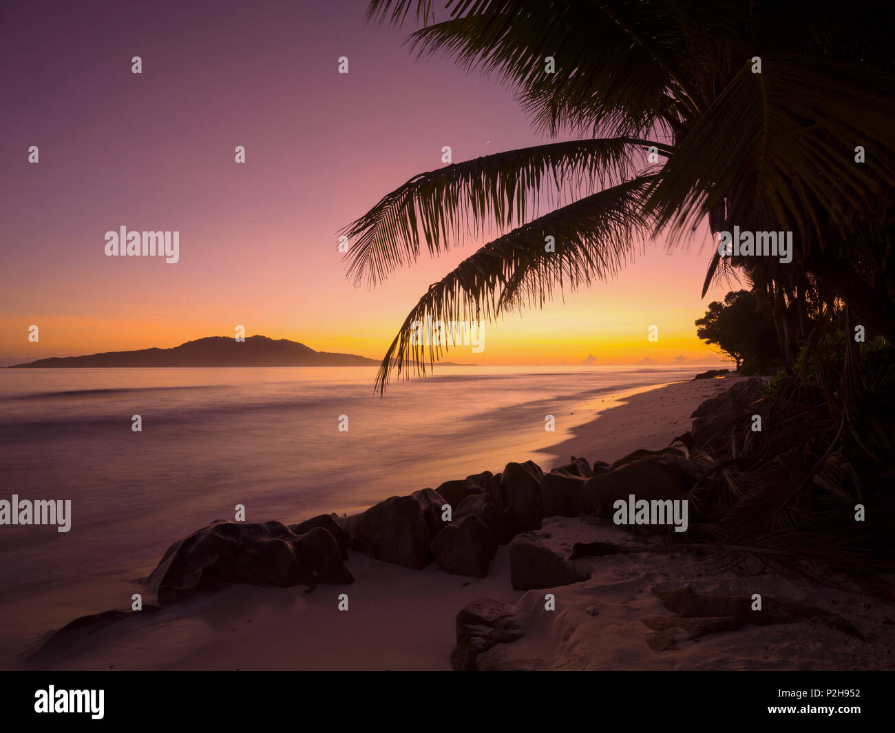 Beach in the evening light, Anse Gaulettes, La Digue Island, Seychelles Stock Photo