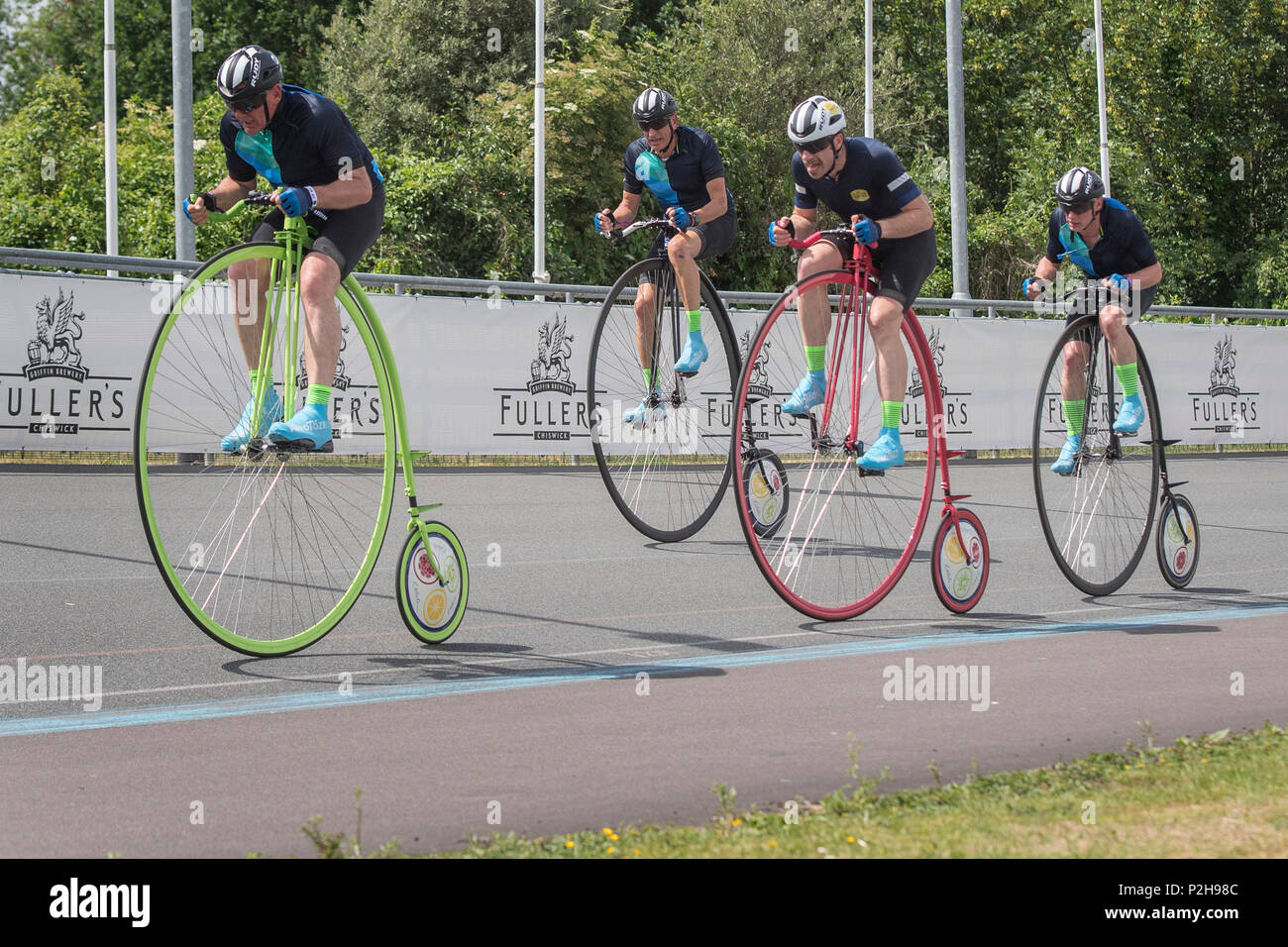 Cyclist Mark Beaumont (on pink bike) on his way to break the R White's Penny Farthing One Hour World Record at the World Cycling Revival Festival at Herne Hill Velodrome in Dulwich Village, London. Stock Photo