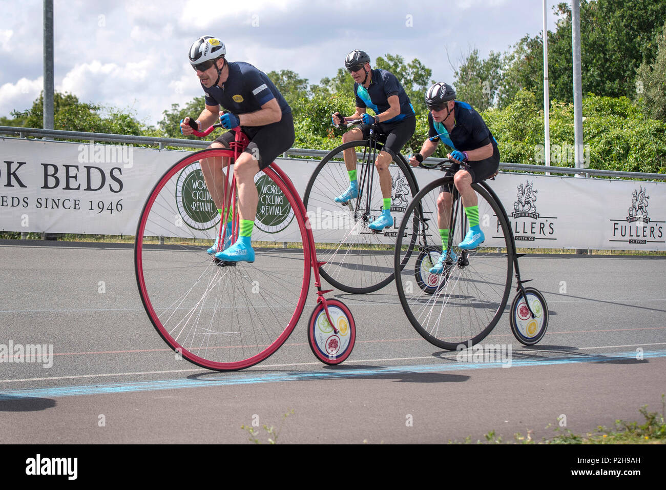 Cyclist Mark Beaumont (on pink bike) on his way to break the R White's Penny Farthing One Hour World Record at the World Cycling Revival Festival at Herne Hill Velodrome in Dulwich Village, London. Stock Photo