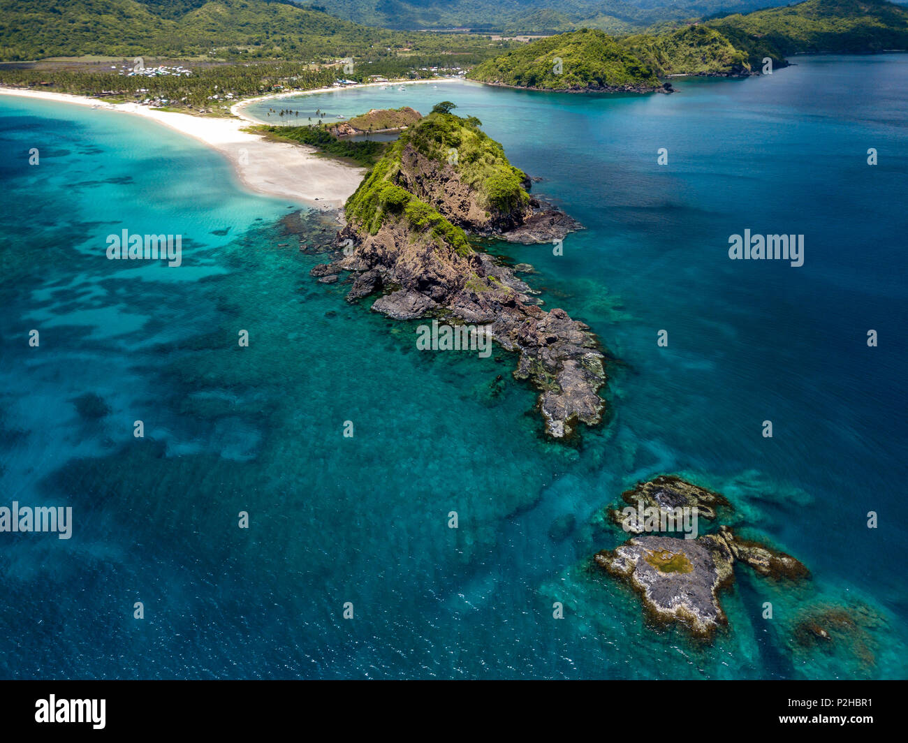 Aerial drone view of twin tropical beaches surrounded by coral reef and a clear ocean Stock Photo