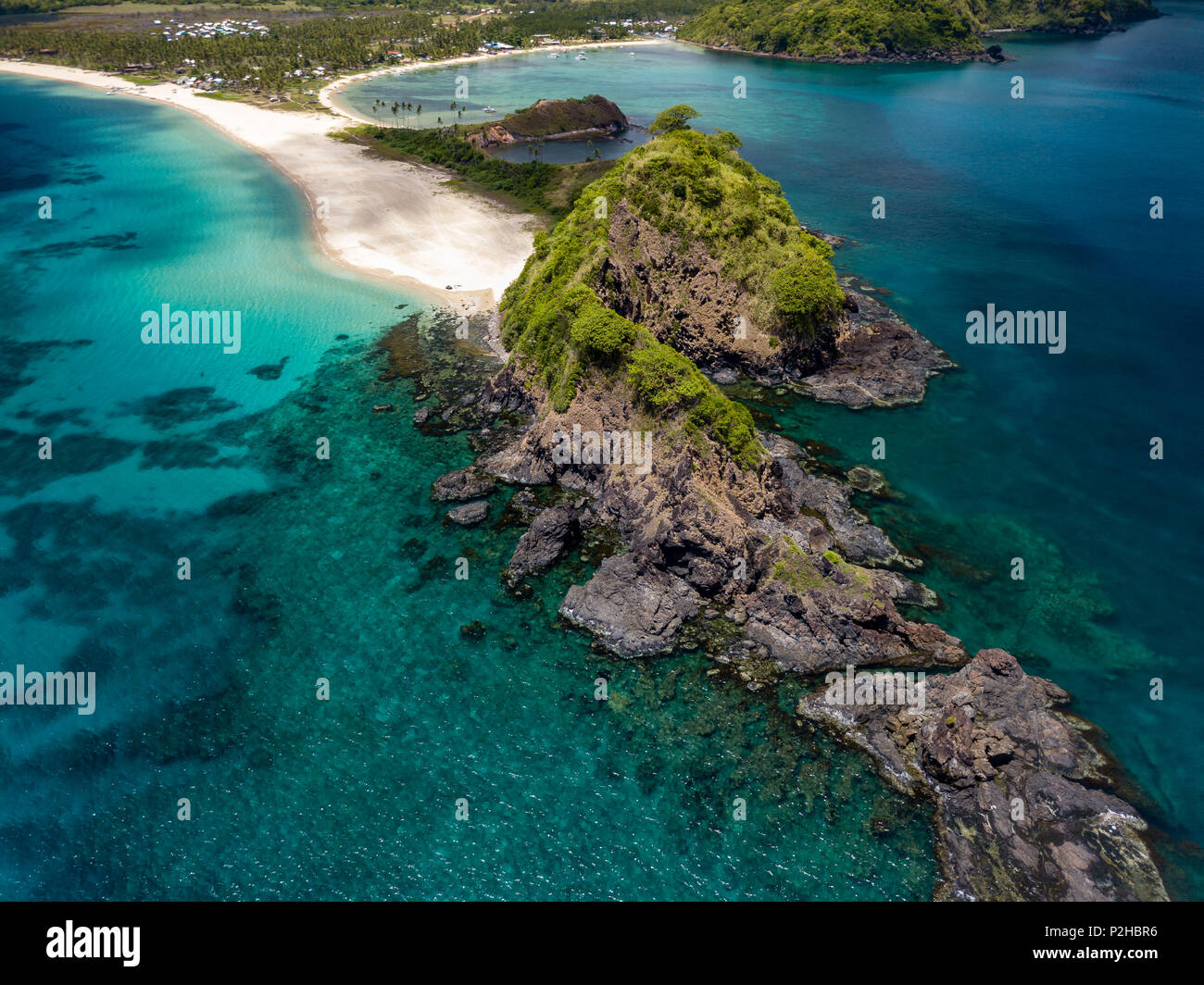 Aerial drone view of twin tropical beaches surrounded by coral reef and a clear ocean Stock Photo