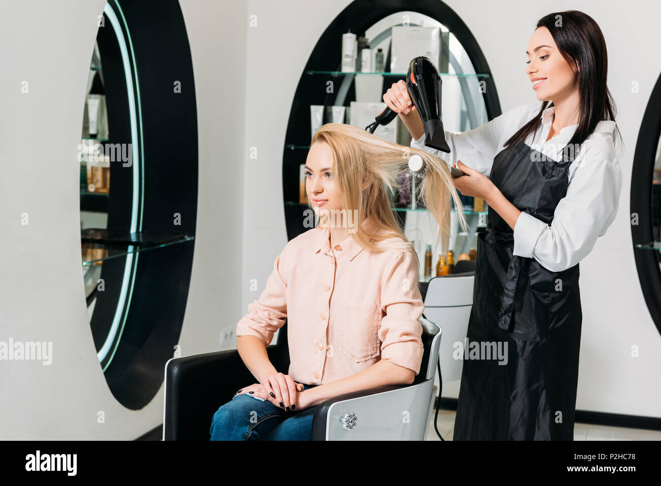 hairdresser drying customer hair at salon Stock Photo - Alamy