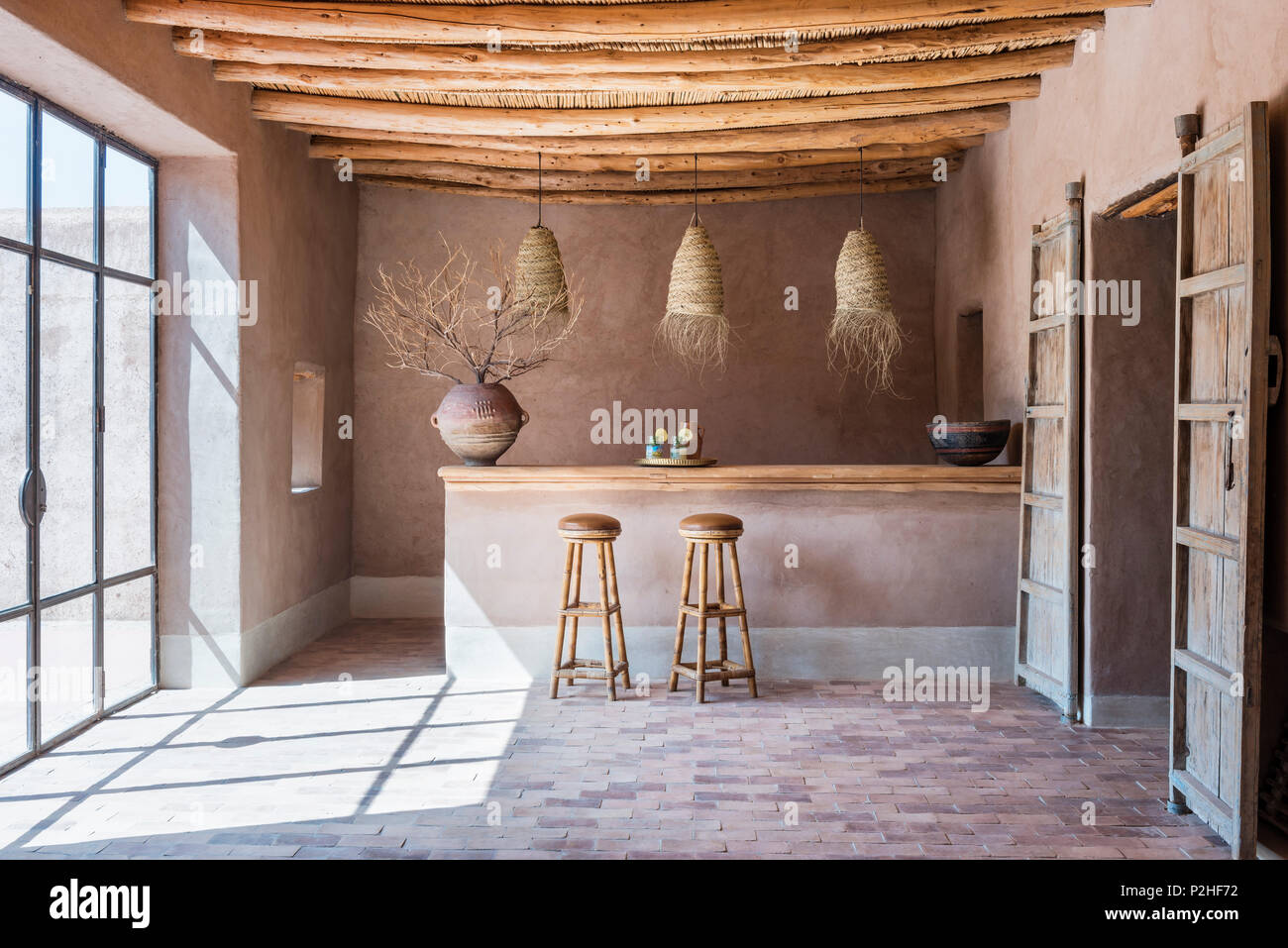Rattan Lanterns Hang Above Counter With Bamboo Bar Stools In Bar