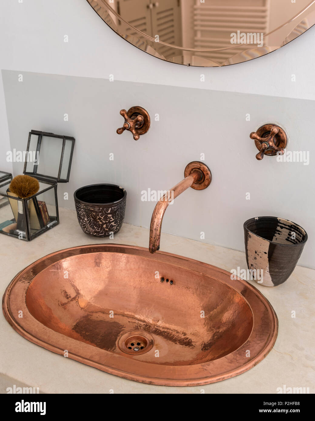 Brass metal sink in washstand unit with vintage tap fittings in Luberon farmhouse. Stock Photo