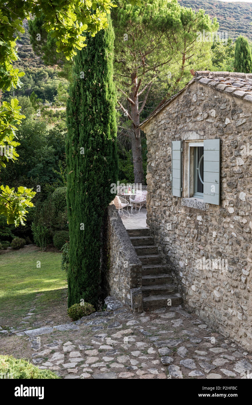 Exposed stone exterior and steps to terrace of Luberon farmhouse. Stock Photo