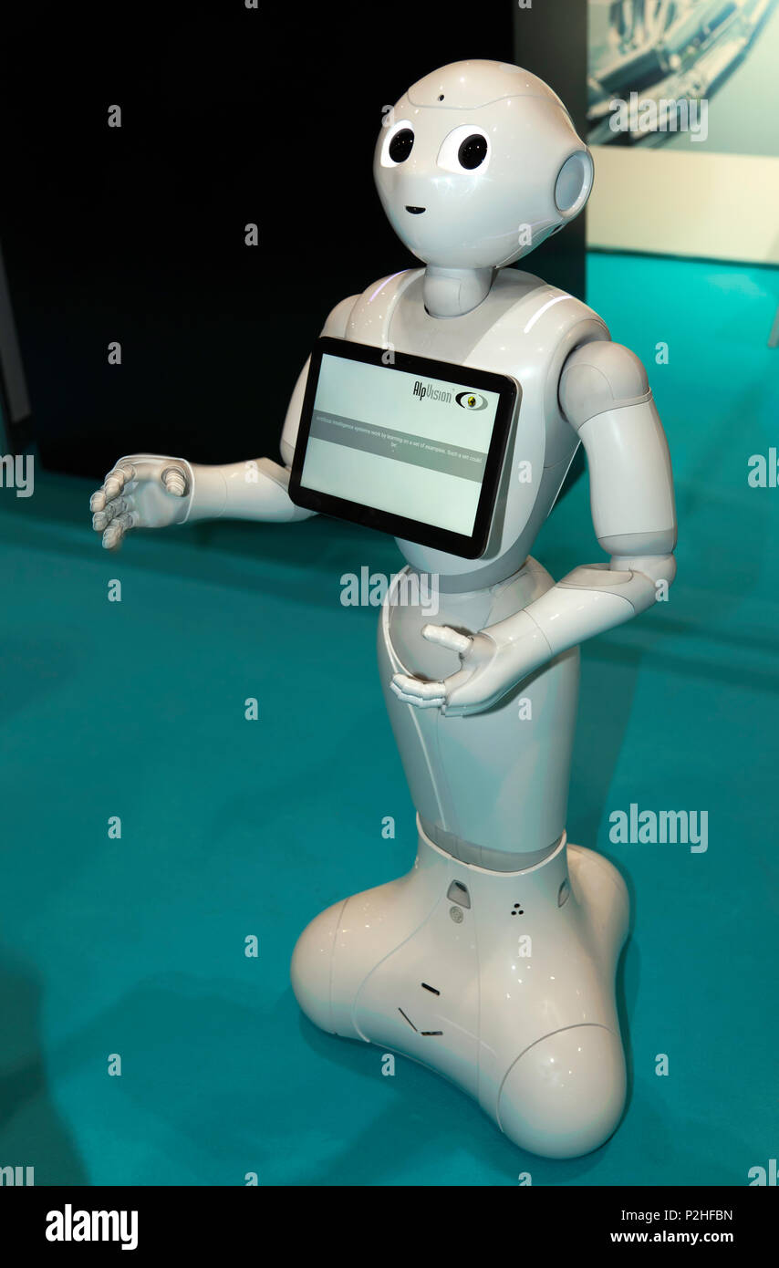 Pepper, a humanoid social robot, on the AlpVision stand at the 2018 AI Summit, interacting with Delegates.. Stock Photo