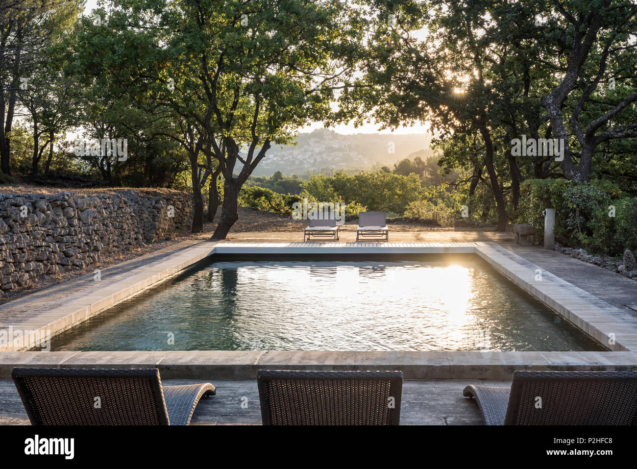 Poolside recliners in grounds of Luberon farmhouse. Stock Photo