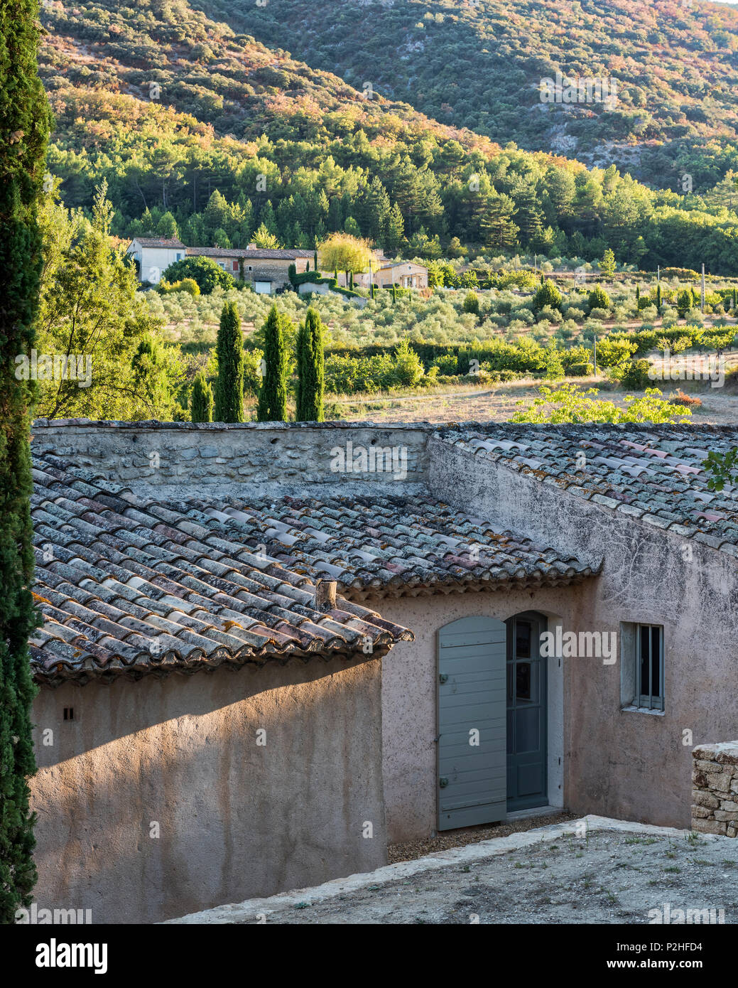 Tiled rooftop of renovated Luberon farmhouse on hillside Stock Photo