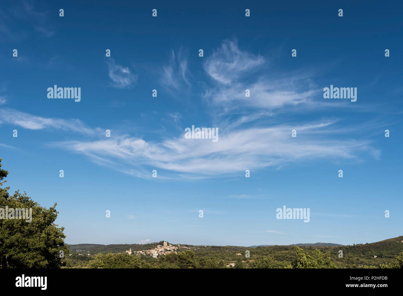 Vast sky above hillside community in Provence (possibly Luberon) Stock Photo