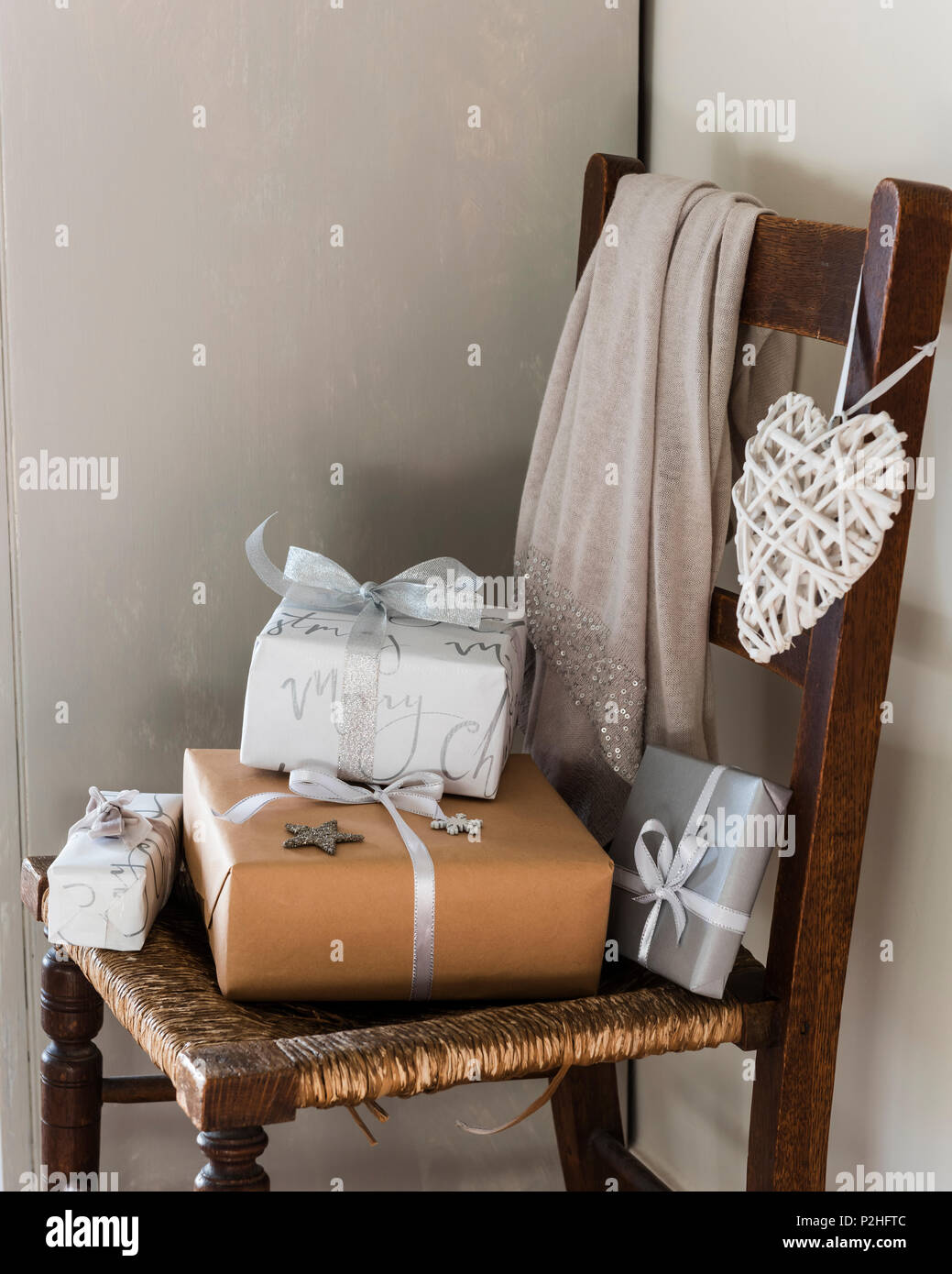 Wrapped presents on wooden chair Stock Photo