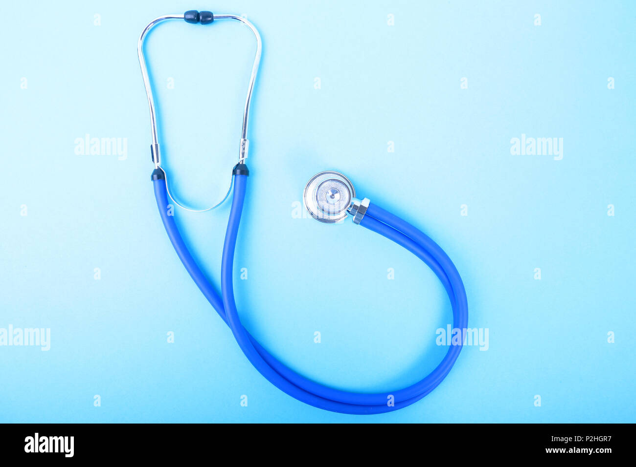 Medical blue stethoscope isolated on blue background. Stock Photo