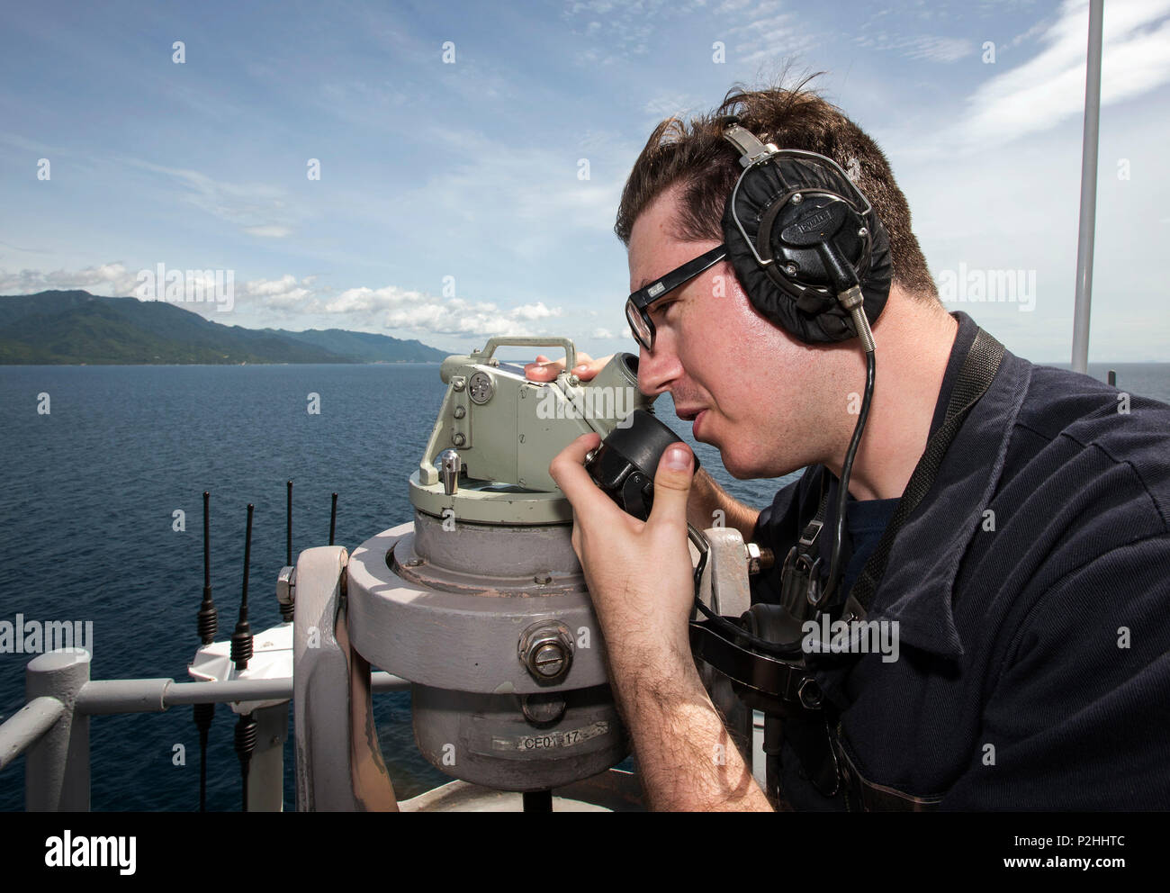 160927-N-WF272-049 WATERS NEAR THE PHILIPPINES (Sept. 27, 2016) Quartermaster Seaman Tanner Kilgore, from Morristown, Tenn., communicates with the bridge during a forward lookout watch aboard amphibious assault ship USS Bonhomme Richard (LHD 6) as the ship transits near the Philippines. Bonhomme Richard, flagship of the Bonhomme Richard Expeditionary Strike Group, is operating in waters near the Philippines in support of security and stability in the Indo-Asia Pacific region. (U.S. Navy photo by Mass Communication Specialist 2nd Class Diana Quinlan/Released) Stock Photo