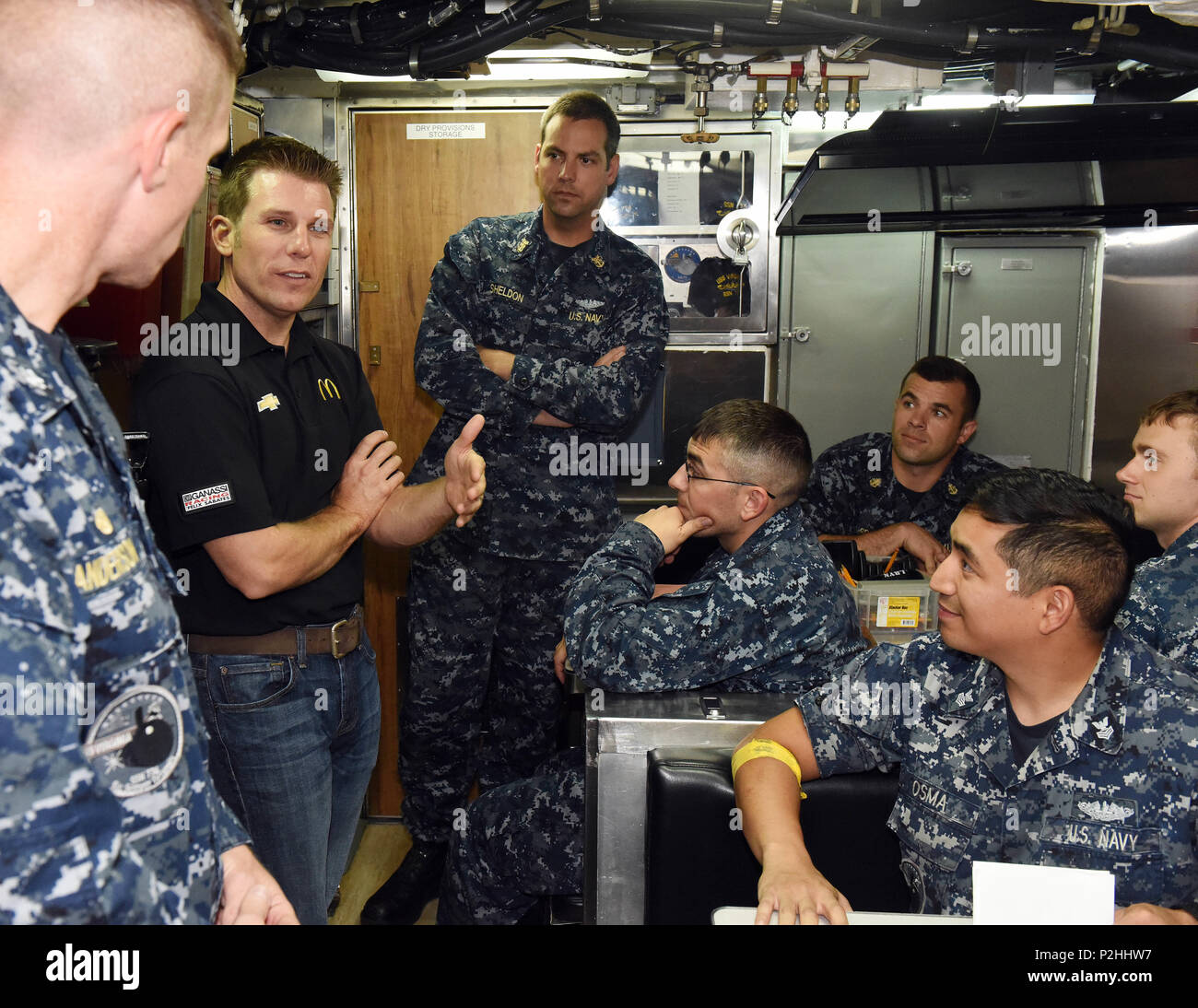 160922-N-SB201-071 GROTON, Conn. (Sept. 22, 2016) Jamie McMurray, driver of the McDonald’s number 1 car for Chip Ganassi Racing, answers questions from USS Virginia (SSN-774) crewmembers in the crew’s mess during a tour of the nuclear-powered, fast-attack submarine. USS Virginia, first-in-class of the Virginia-class of fast-attack submarines is homeported at Naval Submarine Base New London. (U.S. Navy Photo by Chief Mass Communication Specialist(SW/AW) Steve Owsley/Released). Stock Photo