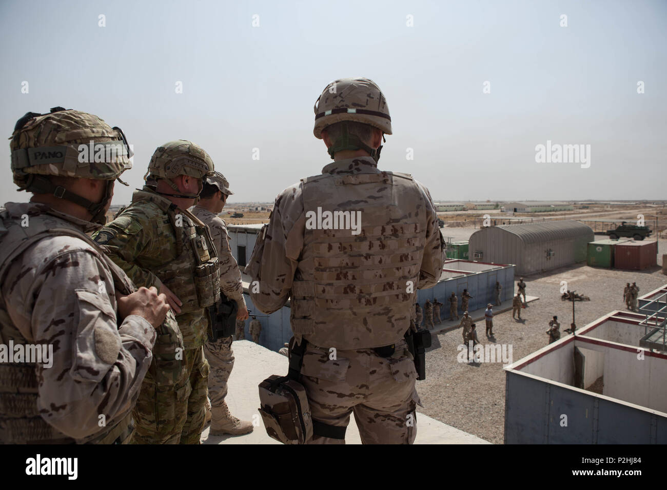 Spanish Col. Vazquez de Prada, right, the Besmaya task force commander, shows Australian Brigadier Roger Noble, center, the deputy commanding general of the Combined Joint Forces Land Component Command – Operation Inherent Resolve, the training occurring at the Besmaya Range Complex, Iraq, Sept. 26, 2016. The training conducted by Iraqi soldiers allows Spanish coalition trainers to assess their capabilities. Training at building partner capacity sites is an integral part of Combined Joint Task Force – Operation Inherent Resolve’s multinational effort to train Iraqi security forces personnel to Stock Photo