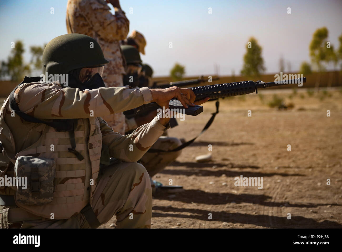 A Peshmerga soldier loads his M16 rifle during a chemical, biological ...