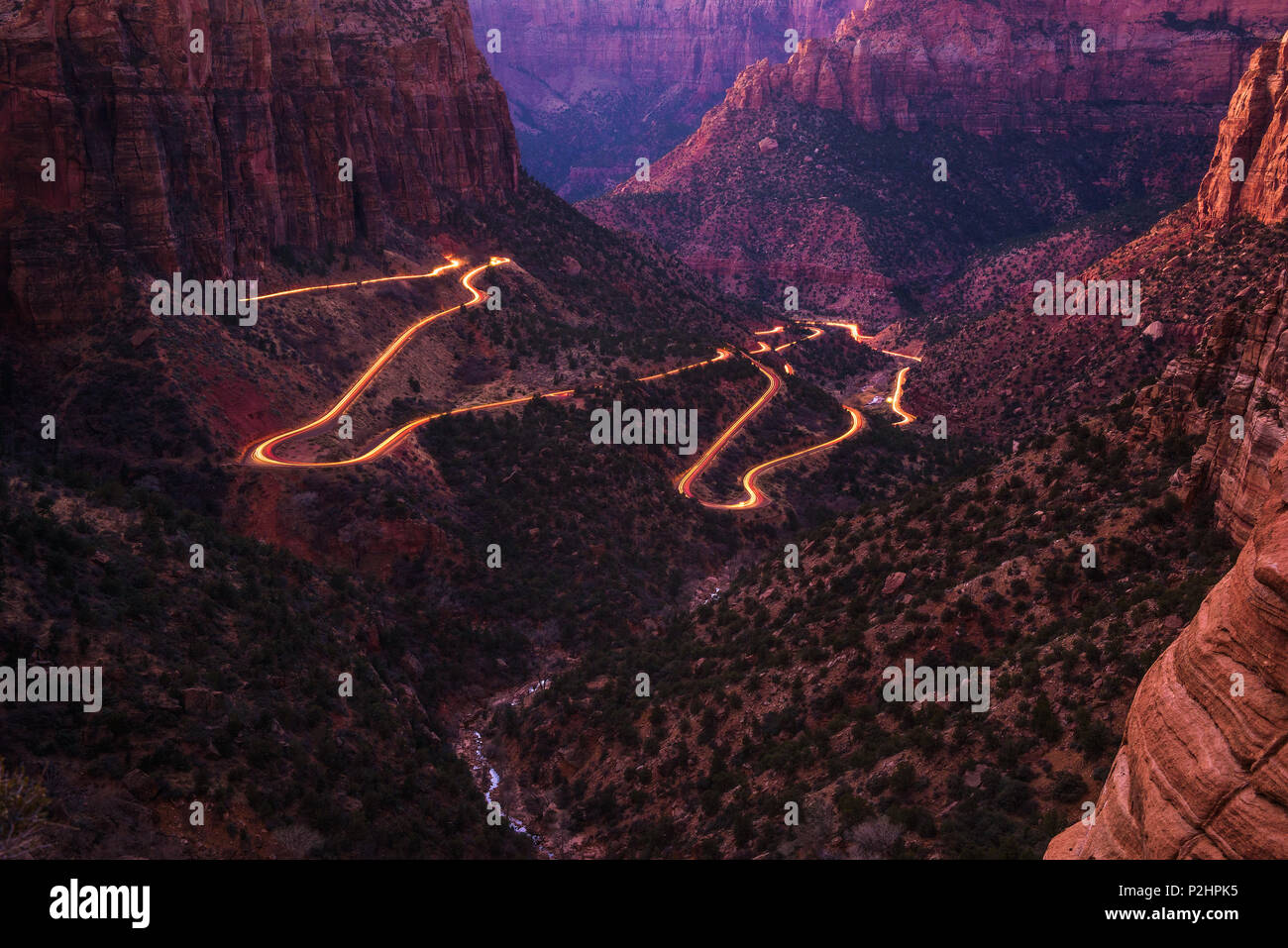Road in Zion National Park with car light trails Stock Photo