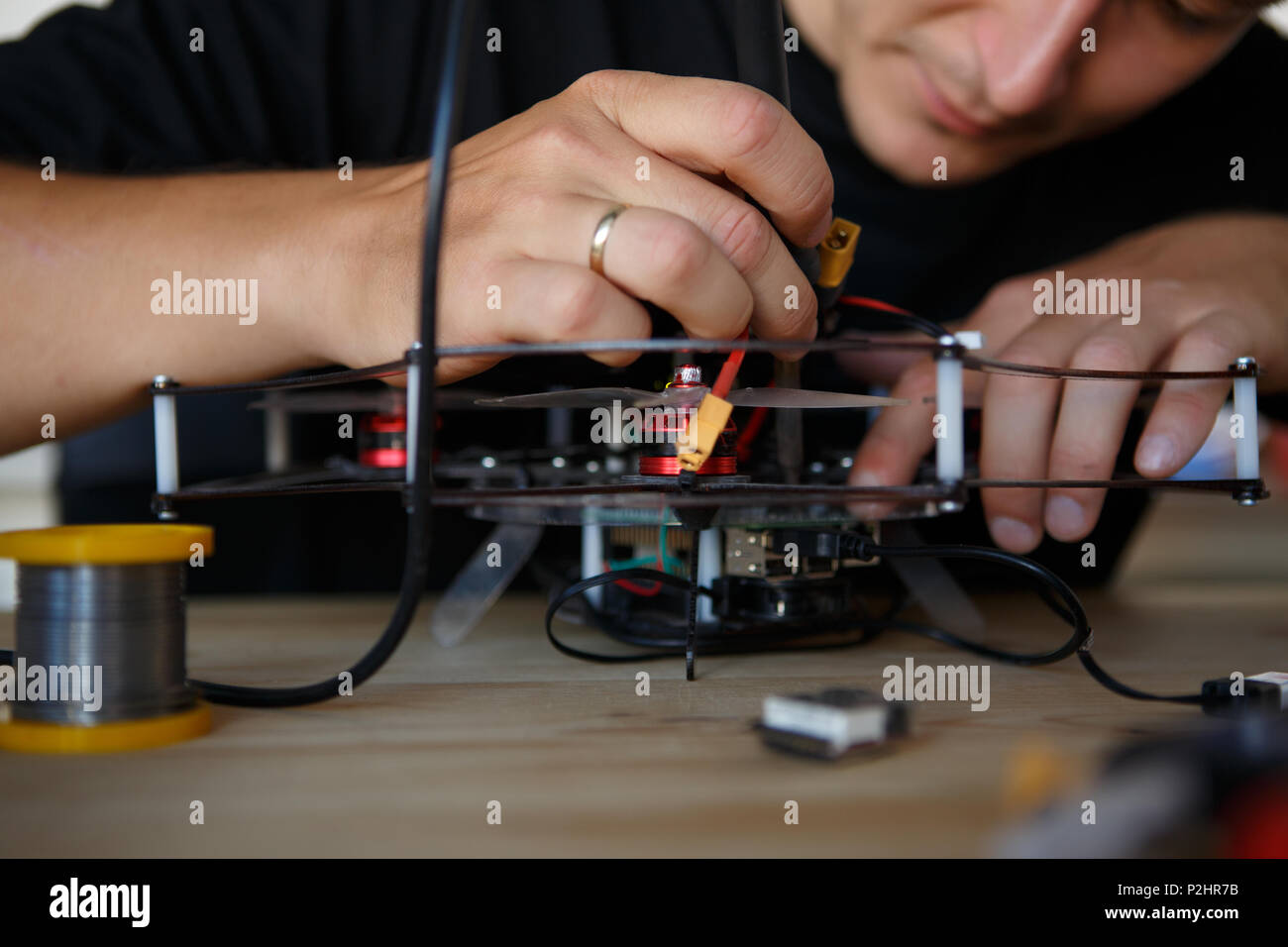 Picture of young man with soldering iron chipping mechanism Stock Photo Alamy