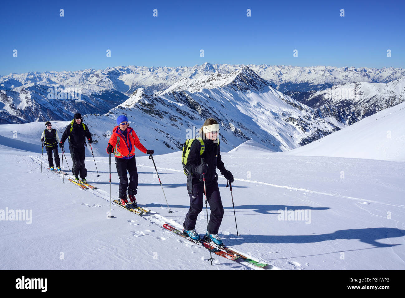 Several persons back-country skiing ascending towards Kleiner Kaserer, Hohe Warte and Stubai Alps in the background, Kleiner Kas Stock Photo