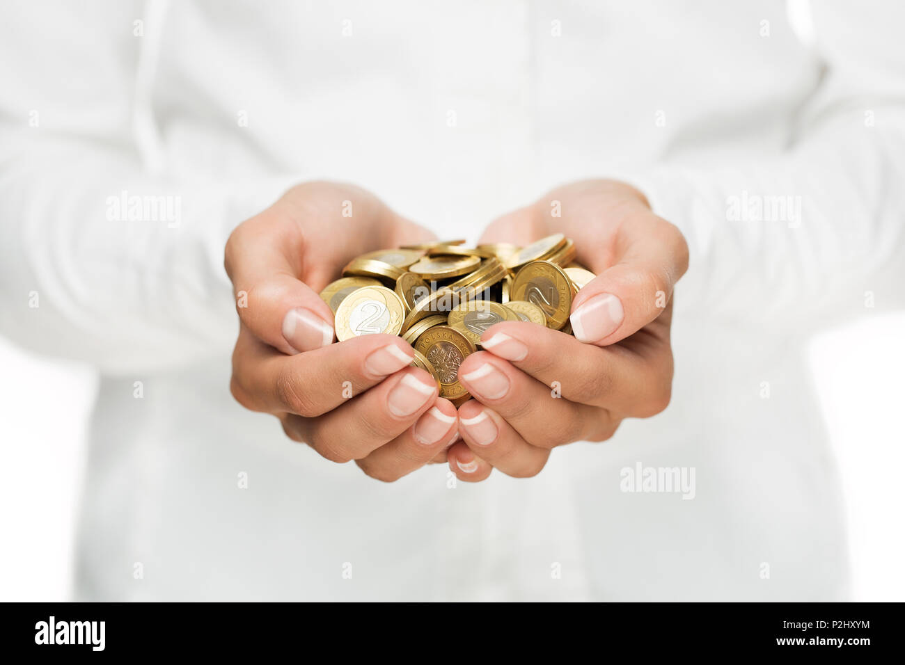 Savings, close up of cupped female hands holding golden coins Stock Photo