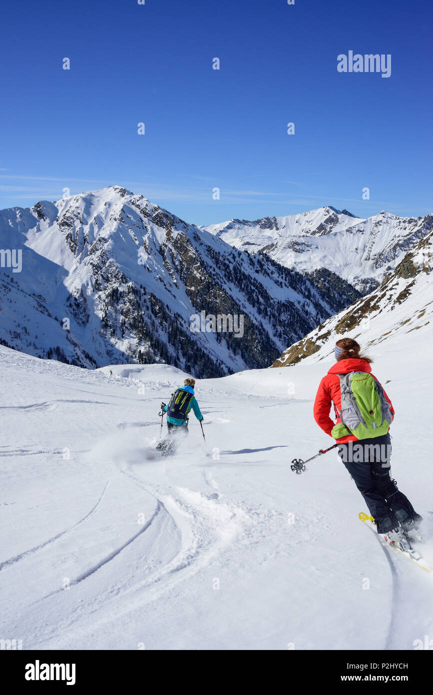 Two persons back-country skiing downhill from Frauenwand, Frauenwand, valley of Schmirn, Zillertal Alps, Tyrol, Austria Stock Photo