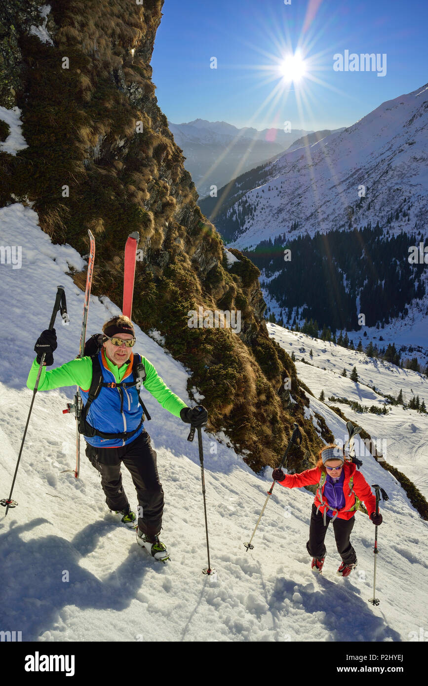 Two persons back-country skiing ascending through steep gully towards Schneespitze, Schneespitze, valley of Pflersch, Stubai Alp Stock Photo
