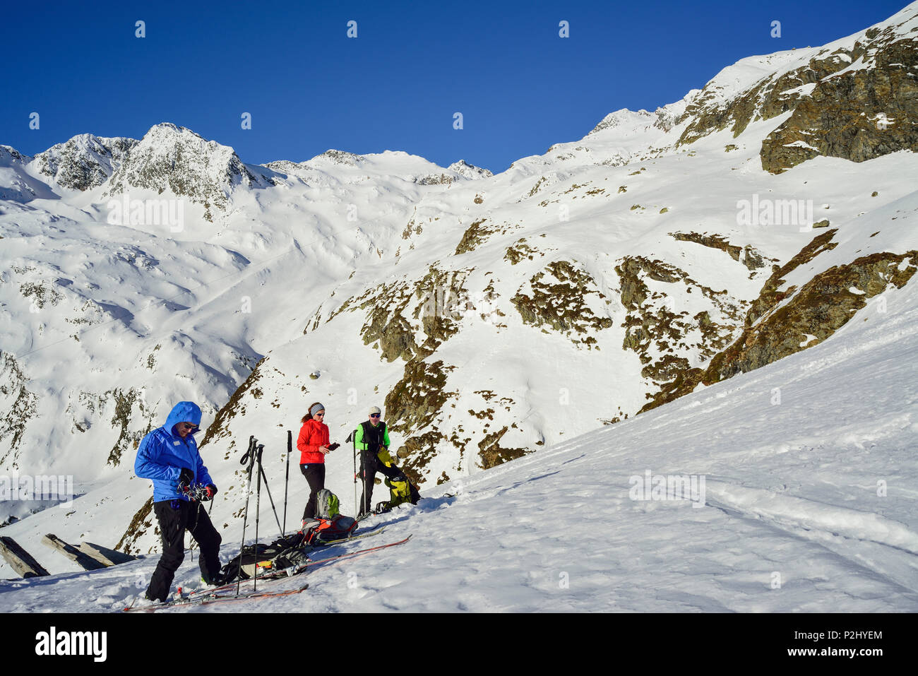 Three persons back-country skiing ascending towards Schneespitze, Schneespitze, valley of Pflersch, Stubai Alps, South Tyrol, It Stock Photo