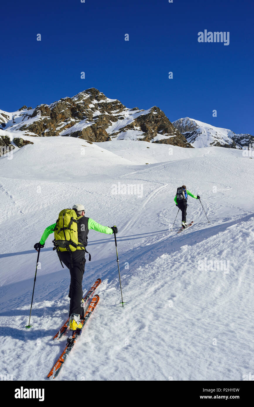 Two persons back-country skiing ascending towards Schneespitze, Schneespitze, valley of Pflersch, Stubai Alps, South Tyrol, Ital Stock Photo