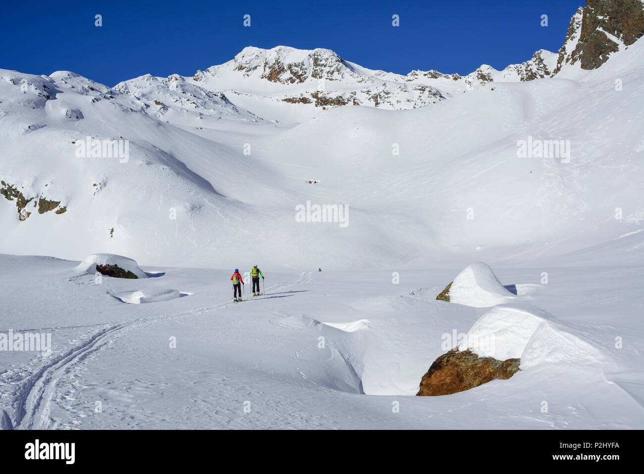 Two persons back-country skiing ascending towards Schneespitze, Schneespitze, valley of Pflersch, Stubai Alps, South Tyrol, Ital Stock Photo