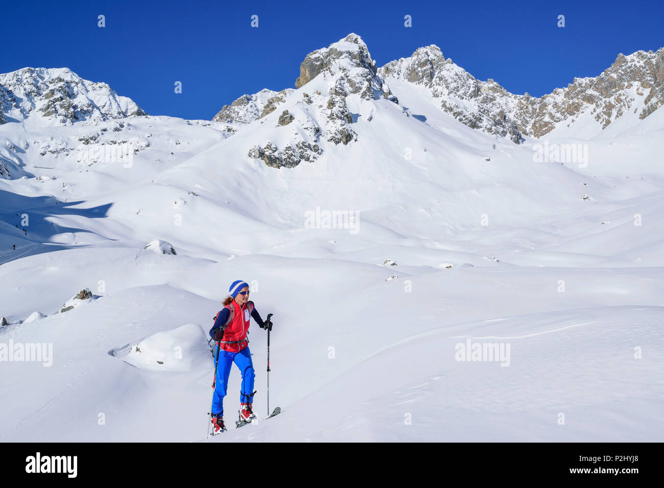 Woman back-country skiing ascending to Col Sautron, Monte Sautron in the background, Col Sautron, Valle Maira, Cottian Alps, Pie Stock Photo