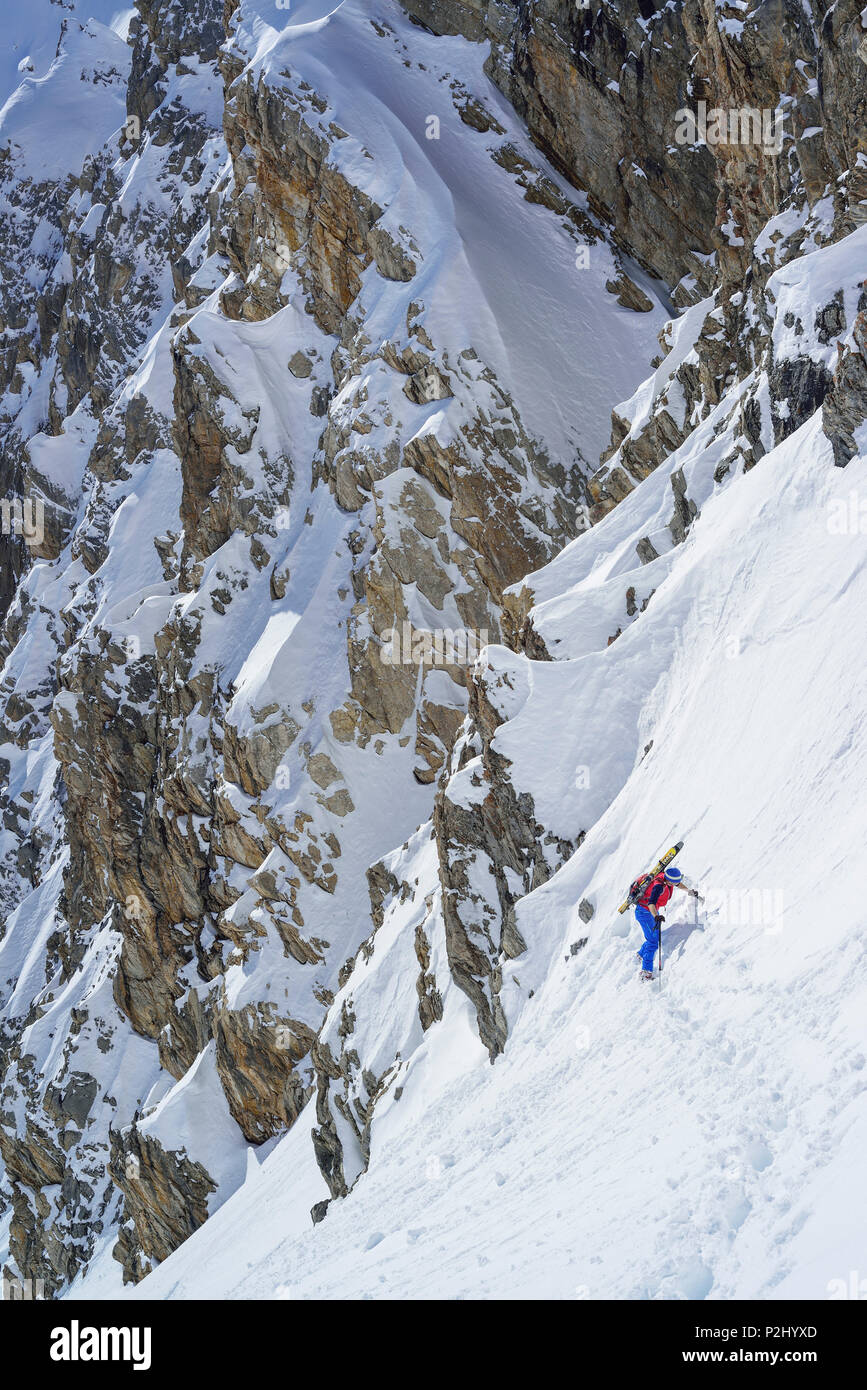 Woman back-country skiing ascending to La Forcellina, Col Sautron, Valle Maira, Cottian Alps, Piedmont, Italy Stock Photo