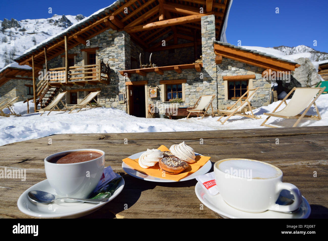Hot chocolate, cappuccino and sweets at Rifugio Viviere, Viviere, Valle Maira, Cottian Alps, Piedmont, Italy Stock Photo