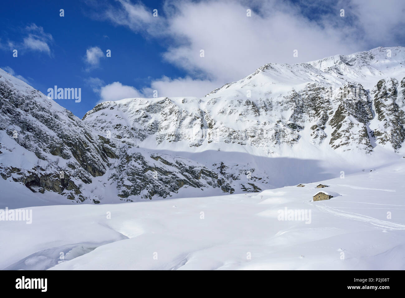 Winter landscape with snow-covered alpine huts, Monte Faraut, Valle Varaita, Cottian Alps, Piedmont, Italy Stock Photo