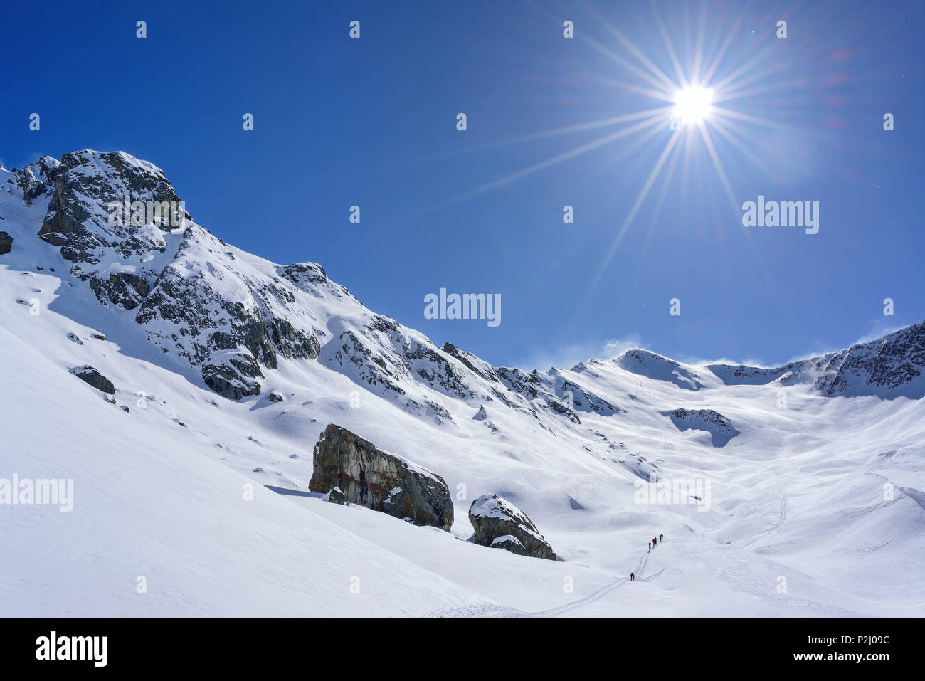 Several persons back-country skiing ascending towards Monte Faraut, Monte Faraut, Valle Varaita, Cottian Alps, Piedmont, Italy Stock Photo