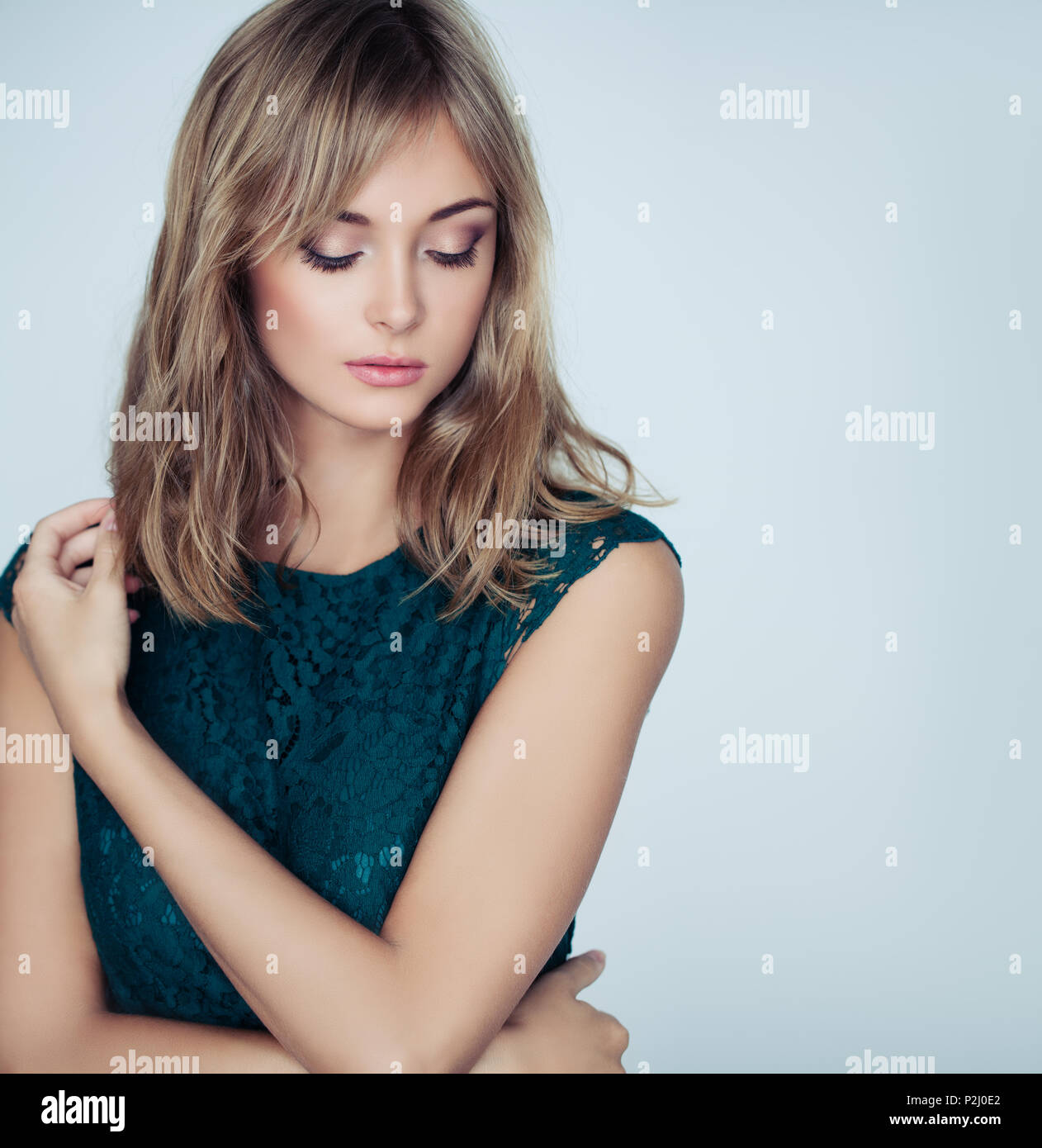 Young Woman With Blonde Hair And Natural Makeup On White
