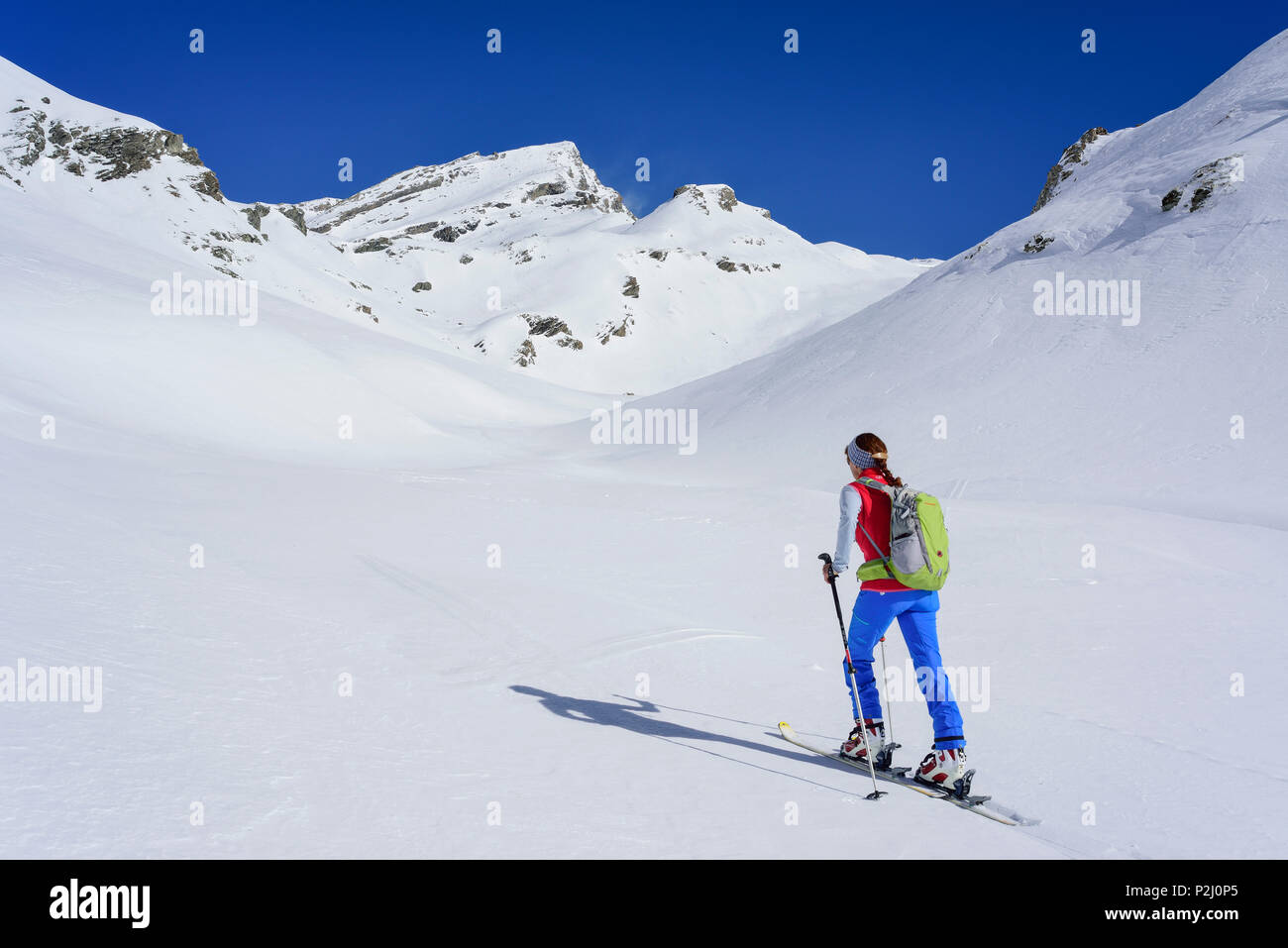 Woman back-country skiing ascending towards Monte Salza, Monte Salza, Valle Varaita, Cottian Alps, Piedmont, Italy Stock Photo