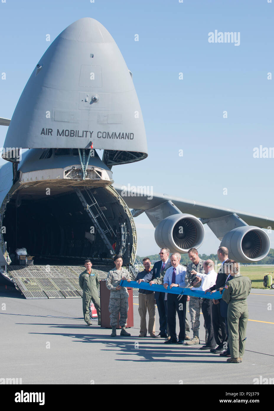 Col. Ethan Griffin, 436th Airlift Wing commander, and Sen. Chris Coons, D-Del.,; cut a ribbon marking the reopening of Runway 01-19 during anafter completion of Phase II of an extensive reconstruction project Sept. 23, 2016, at Dover Air Force Base, Del. Shown from left, Airman 1st Class Joseph Cho, 436th Aircraft Maintenance Squadron; Tony Price, sub-contractor representative; Jeff Wagonhurst, Versar Inc. president and CEO; Col. Scott Durham, 512th AW commander; Sen. Tom Carper, D-Del.; Col. Ethan Griffin, 436th AW commander; Sen. Chris Coons, D-Del.; Drew Slater, Rep. John Carney D-Del. repr Stock Photo