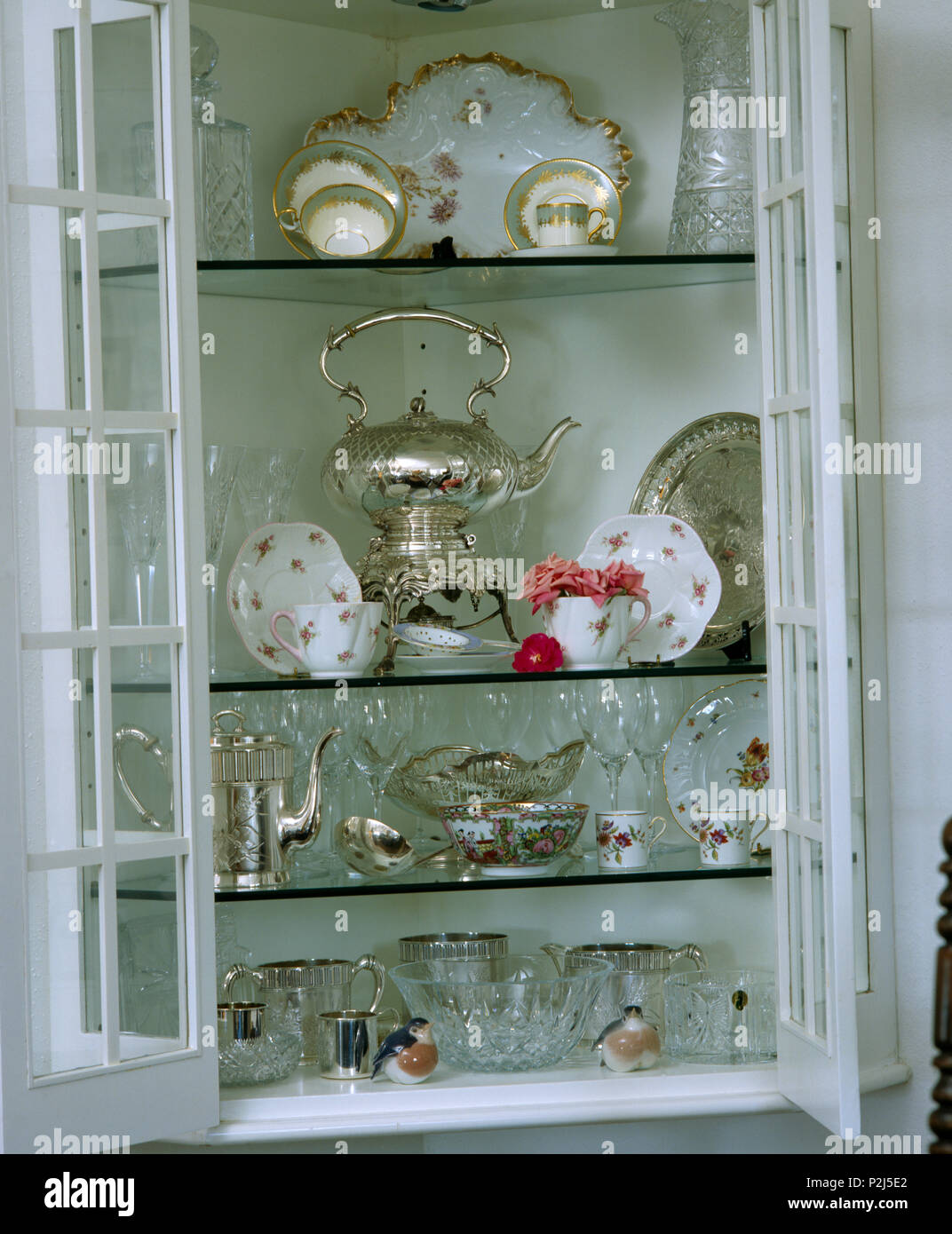 Close Up Of A Wall Cupboard With Antique Silverware And China On