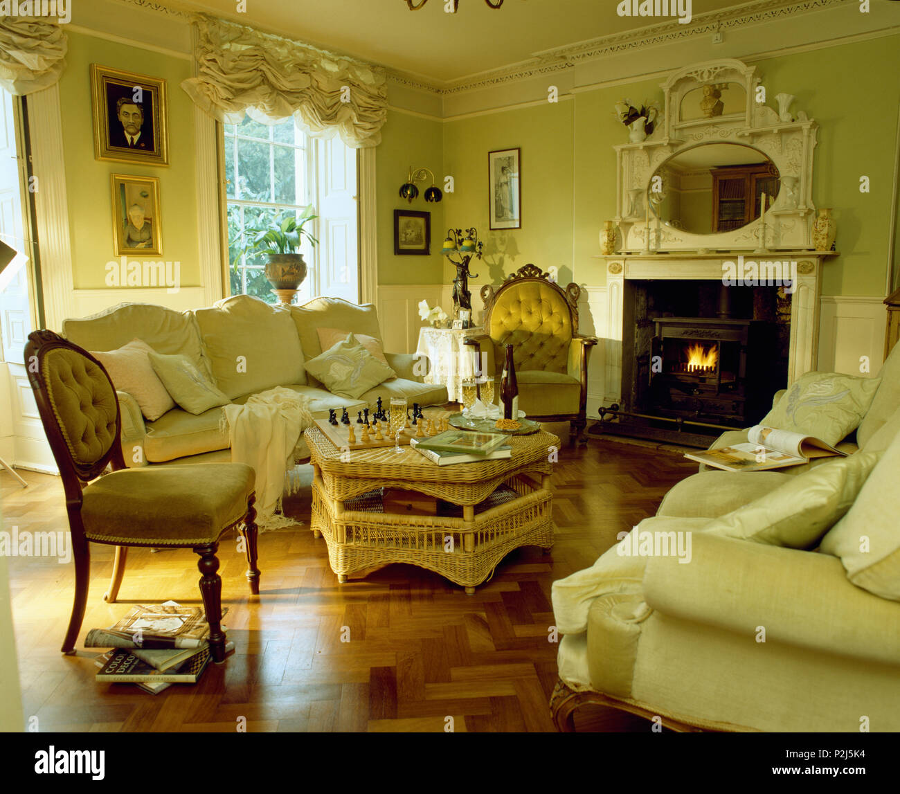 Cream sofas in traditional living roomwirth paqrquet flooring Stock