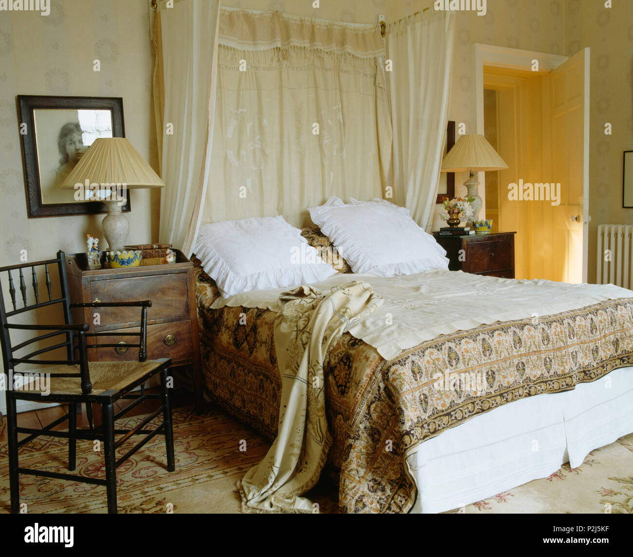 White Pillows And Patterned Throw On Antique Half Tester Bed