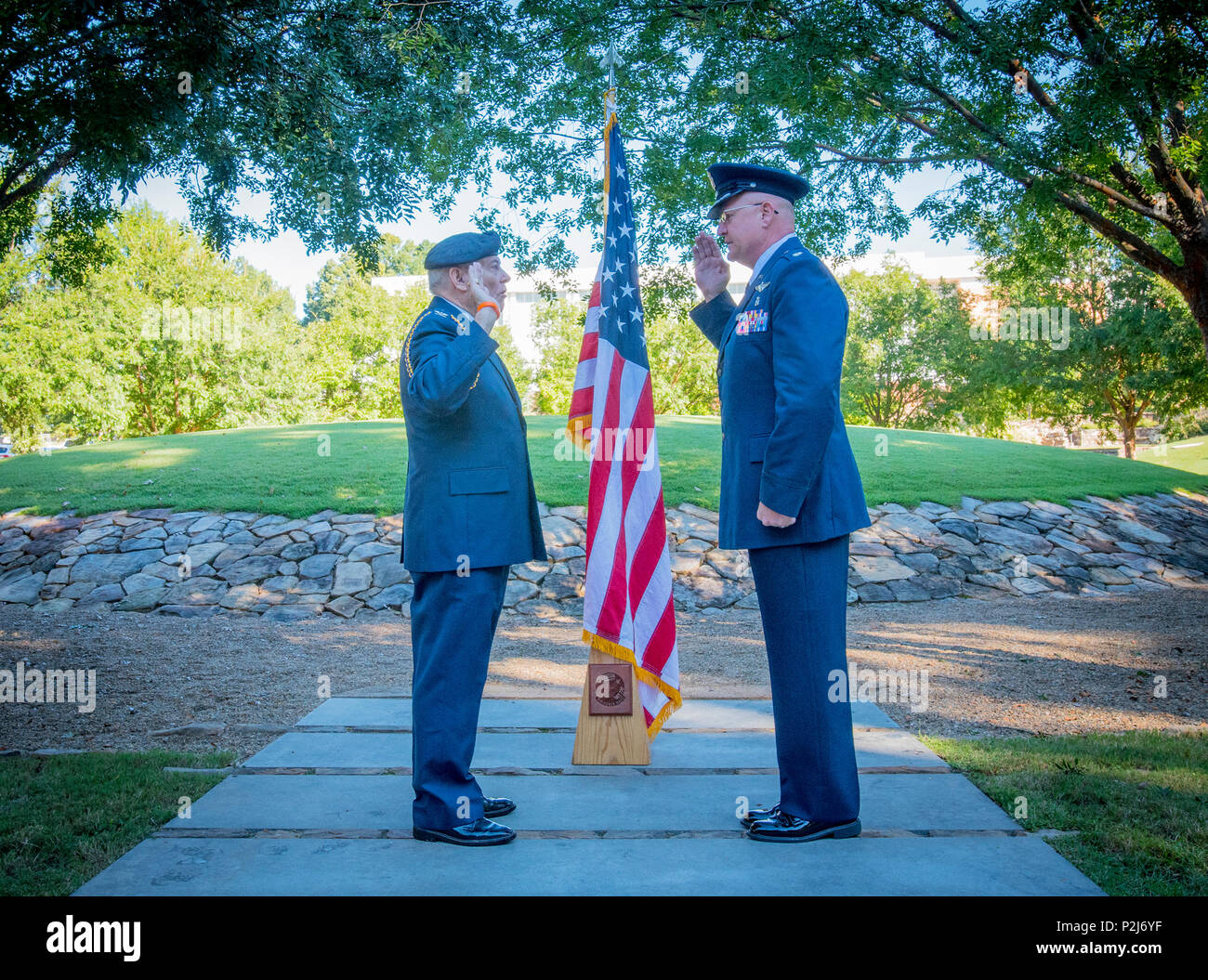 Retired U.S. Air Force Col. Sandy Edge gives the Oath of Office to Lt. Col. Michael E. Mac Lain during Mac Lain’s promotion ceremony at the Scroll of Honor in Clemson University’s Memorial Park, Sept. 30, 2016. Mac Lain is the Aeromedical Operations Flight Commander for the 43rd  Aeromedical Evacuation Squadron, Pope Army Airfield, Fort Bragg, NC. He directs daily flight operations for 60 assigned personnel, and provides medical care as a Flight Nurse on aeromedical evacuation missions. Mac Lain has deployed nine times to combat zones and successfully aero medically evacuated over 700 of the m Stock Photo